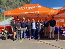 Team of workers or staff gathered at a safety awareness event promoting barrier installation and roadwork safety practices.
