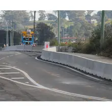 Highway with concrete safety barriers installed along the edge, enhancing roadside protection and traffic safety.