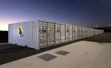 Stacked storage containers at an industrial site, illustrating large-scale storage, shipping, or construction operations.